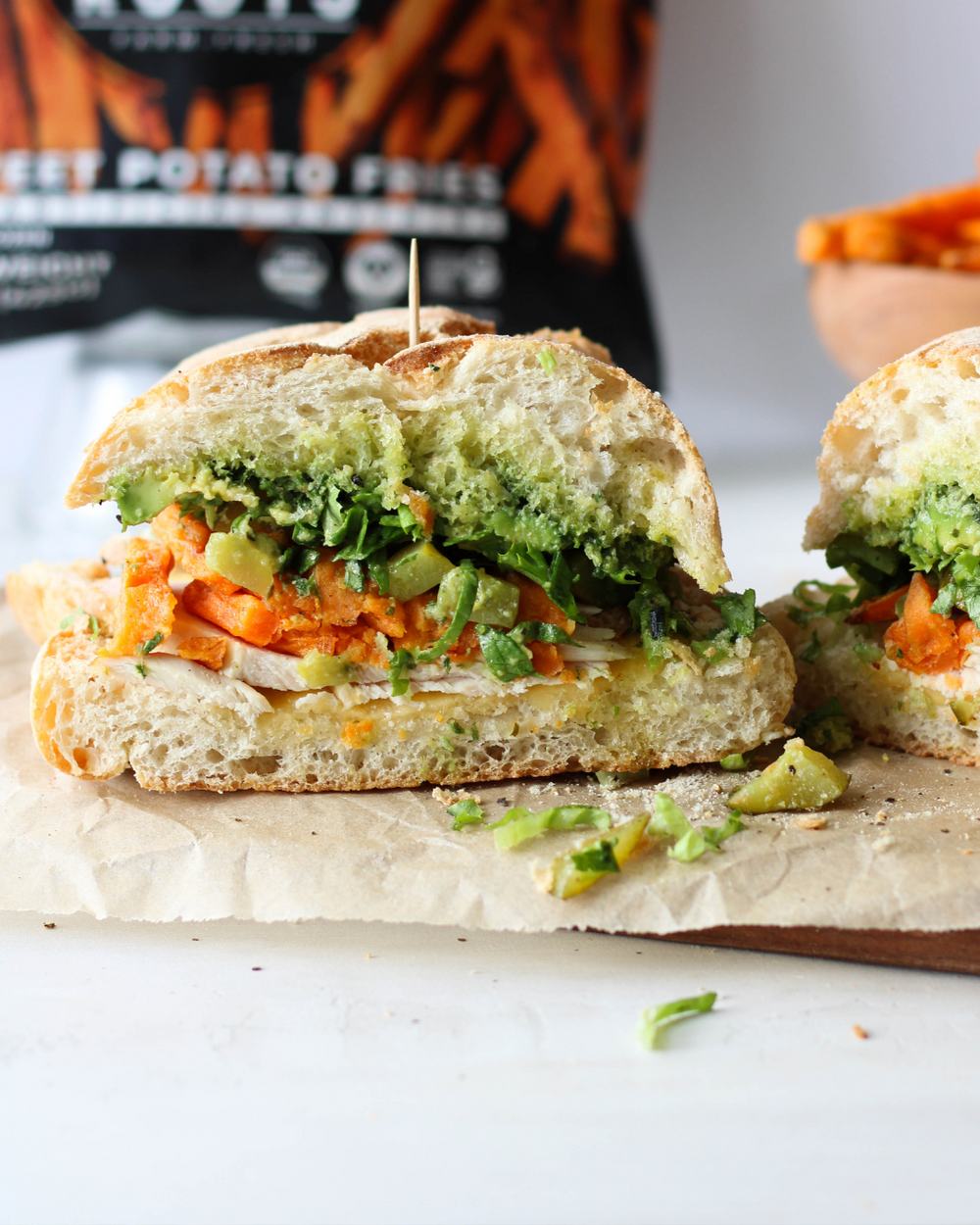 Sweet and Savory Turkey Sandwich with Walnut Pesto, Gouda, Avocado, Pickles, and Crispy Sweet Potato Fries